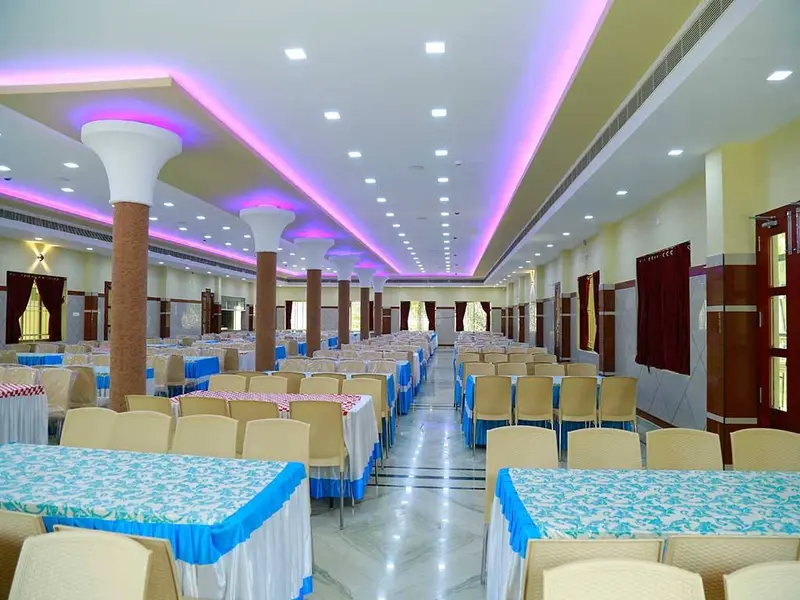 Dining hall with decorated tables and coloured ceiling lights